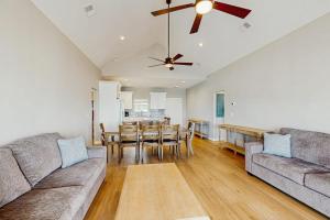 a living room with a couch and a dining table at A Shore Thing in Edisto Beach
