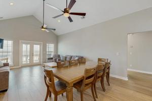 a dining room with a table and chairs at A Shore Thing in Edisto Beach +19 photos
