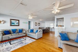 a living room with two couches and a table at Sunrise, Sunset in Edisto Beach