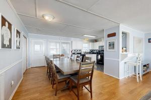 a dining room and kitchen with a table and chairs at Sunrise, Sunset in Edisto Beach