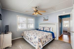 a bedroom with a bed and a ceiling fan at Sunrise, Sunset in Edisto Beach +22 photos