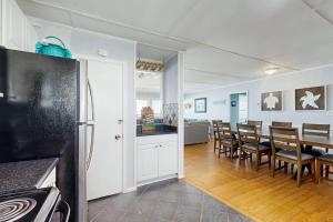 a kitchen and dining room with a table and chairs at Sunrise, Sunset in Edisto Beach