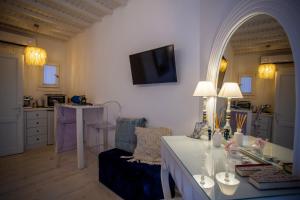 a living room with a table and a couch at Fino Amore Private Jacuzzi Suite in Mykonos Town in Mikonos
