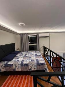 a bedroom with a bed with a quilt on it at Munay House in Tarapoto