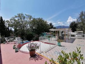 a patio with a fence and a table and a gazebo at Hotel Elohim Tequis in Tequisquiapan