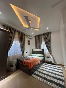 a bedroom with a bed and a ceiling fan at Dreamland prestige Homes in Sasabi