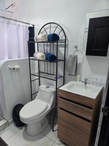 a bathroom with a toilet and a sink at Apartamentos Torres Manuel Antonio in Manuel Antonio +29 photos