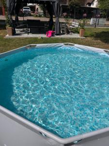 a large swimming pool with blue water at Pokoje I Apartamenty Polna 19 in Niechorze