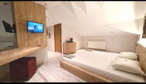 a bedroom with a bed with a tv on the wall at Buhara 93 House - Sultanahmet in Istanbul +28 photos