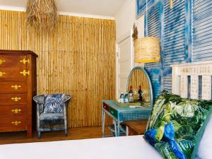 a bedroom with a bed and a table and a mirror at SeaViu Camps Bay in Cape Town
