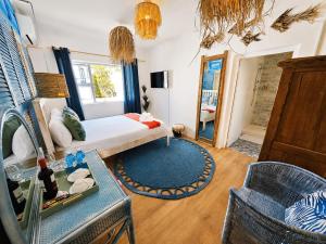 a bedroom with a bed and a table and a mirror at SeaViu Camps Bay in Cape Town