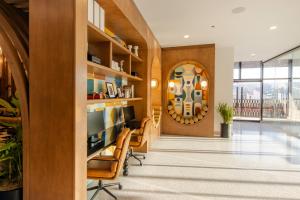 a lobby with chairs and a wall with a window at Hotel Indigo Tijuana Downtown by IHG in Tijuana