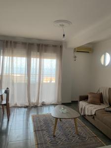 a living room with a couch and a coffee table at T2 vue sur mer in Bejaïa