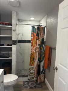 a bathroom with a shower curtain and a toilet at New Haven 5 mi from Legoland in Winter Haven +21 photos