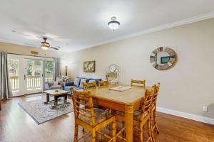 a dining room and living room with a table and chairs at The Tidey Turtle in Edisto Beach +13 photos