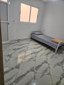 a room with a bed in a room with marble floors at Aerport arwi accom in Nador Airport