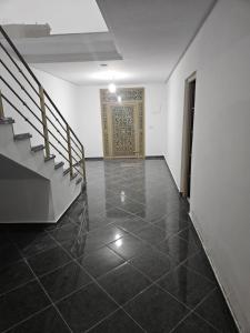 an empty hallway with a door and a tile floor at Aerport arwi accom in Nador Airport