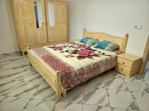 a bedroom with a bed with flowers on it at Aerport arwi accom in Nador Airport