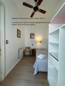 a bedroom with a bed and a ceiling fan at Hotel Frossard in Buenos Aires +26 photos