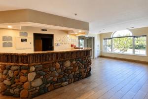 a lobby of a museum with a stone wall at Microtel Inn & Suites by Wyndham Bozeman in Bozeman