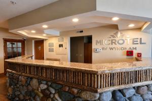 a lobby of a hotel with a sign that reads microsoft by withdrawal at Microtel Inn & Suites by Wyndham Bozeman in Bozeman +25 photos