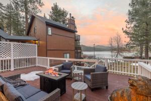 a patio with couches and a fireplace on a deck at Cove Lakeside Jacuzzi, Central AC, Stunning View in Big Bear Lake