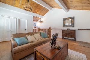 a living room with a couch and a table at Cove Lakeside Jacuzzi, Central AC, Stunning View in Big Bear Lake