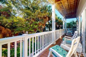 a porch with two chairs and a table at Sea Sea Rider in Edisto Beach