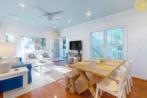 a living room with a table and a couch at Sea Sea Rider in Edisto Beach +17 photos