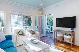 a living room with a couch and a flat screen tv at Sea Sea Rider in Edisto Beach