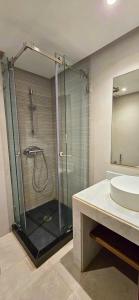 a bathroom with a glass shower and a sink at Villa Séréna Pool and Comfy in Tamaris +21 photos