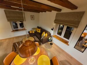 a living room with a table and a couch at Apartamenty Kukinia33 in Kukinia