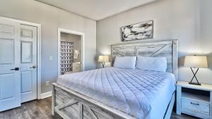 a bedroom with a large bed with a blue comforter at Pet-Friendly Luxury 3BR with Pool Sleeps 8 Near Beach in Myrtle Beach +33 photos