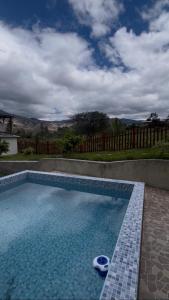a swimming pool with blue tiles in a yard at villa paraíso in Piura