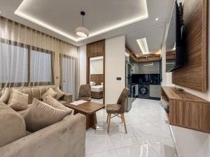 a living room with a couch and a table at LA VILLA Appart in Al Hoceïma