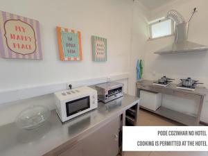 a kitchen with a counter with a microwave on it at HOTEL SLOW STAY - Esposende in Esposende