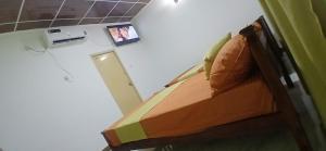 a bedroom with a bed with a picture on the wall at Samadi hotel and resort in Kekirawa