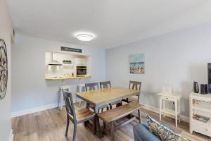 a kitchen and dining room with a wooden table and chairs at Xanadu D8 in Hilton Head Island