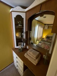 a bathroom with a vanity with a large mirror at Hills View Accommadation in Borrisoleigh