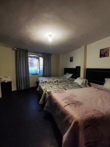 a hotel room with two beds and a window at Deluxe Miraflores in Miraflores +8 photos