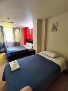 a hotel room with two beds in a room at Deluxe Miraflores in Miraflores