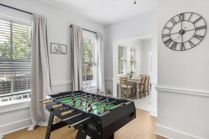 a living room with a foosball table and a clock at Updated 1 BR Home - Steps to 7th Ave in Tampa