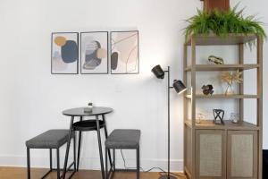 a dining room with a table and two stools at Updated 1 BR Home - Steps to 7th Ave in Tampa