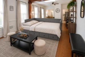 a bedroom with a large bed and a table at Updated 1 BR Home - Steps to 7th Ave in Tampa +15 photos