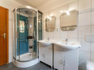 a bathroom with two sinks and a shower at Sternenchalet in Liebenfels +35 photos