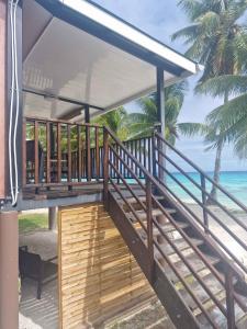 a balcony with a view of the ocean at Takava Lodge in Fakarava +21 photos