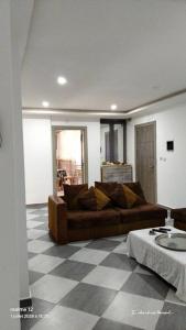 a living room with a couch and a checkered floor at Anis in Annaba