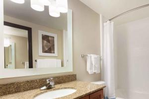 a bathroom with a sink and a mirror at Extended Stay America Suites - Denver - Broomfield in Broomfield +16 photos
