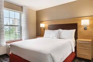 a bedroom with a large bed and a window at Extended Stay America Suites - Denver - Broomfield in Broomfield