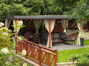 a patio with a gazebo and chairs at Kamień na Kaszubach in Kamień